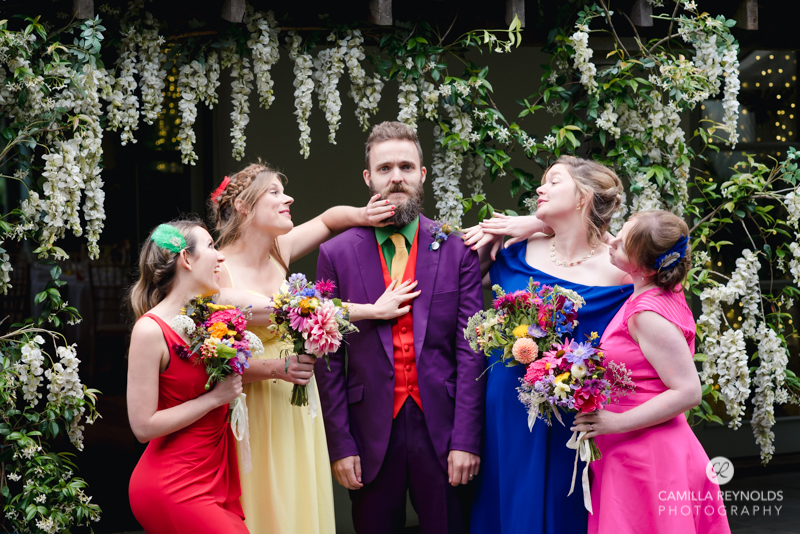 groom and bridesmaids in colourful dresses alternative wedding cotswolds uk