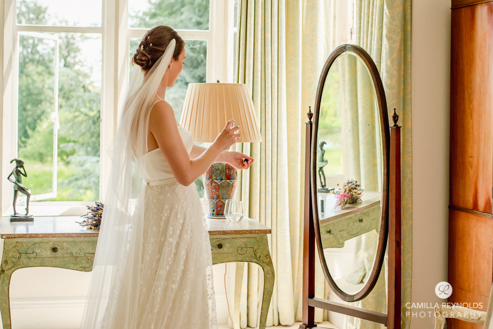bride putting perfume on romantic wedding photography cotswolds