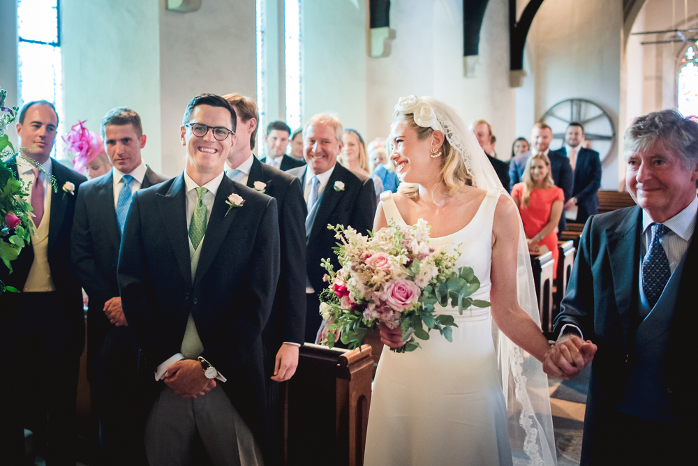 bride walking down the aisle barnsley church cotswolds