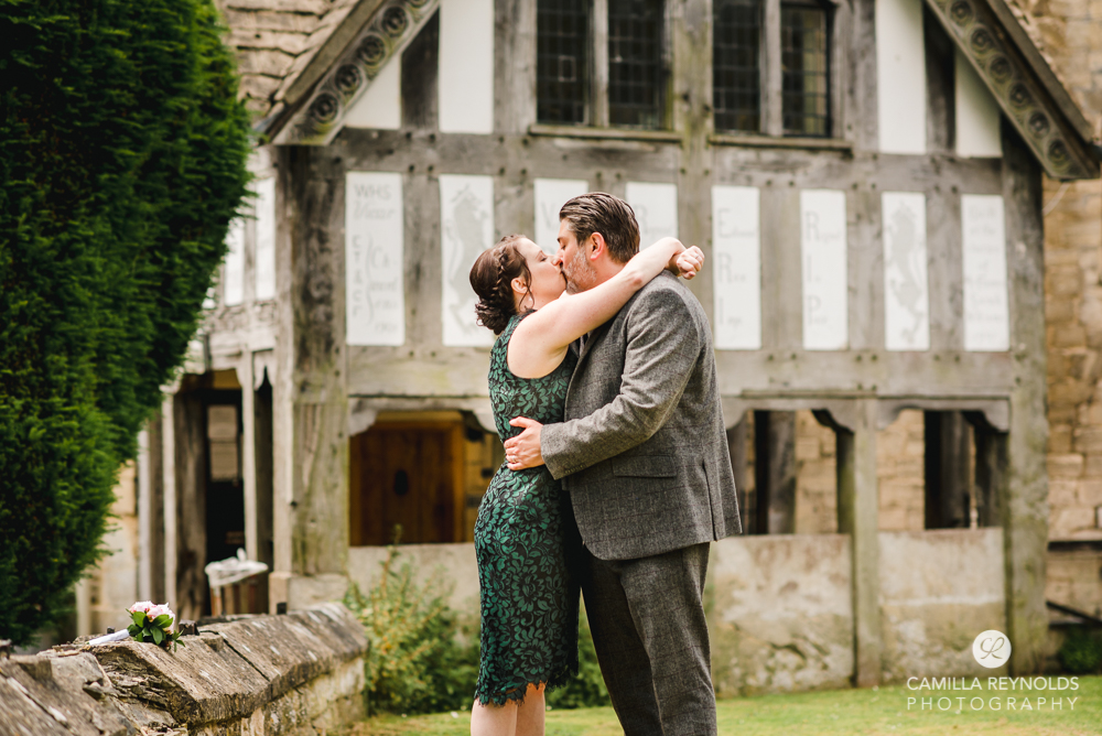 couple kissing old cotswold town engagement photography