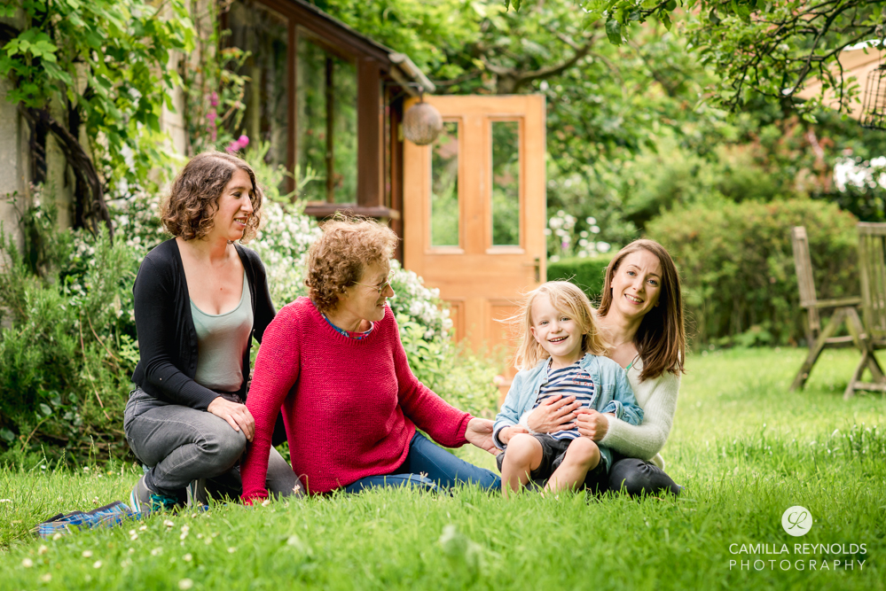 smiling natural  family portrait in the garden gloucestershire