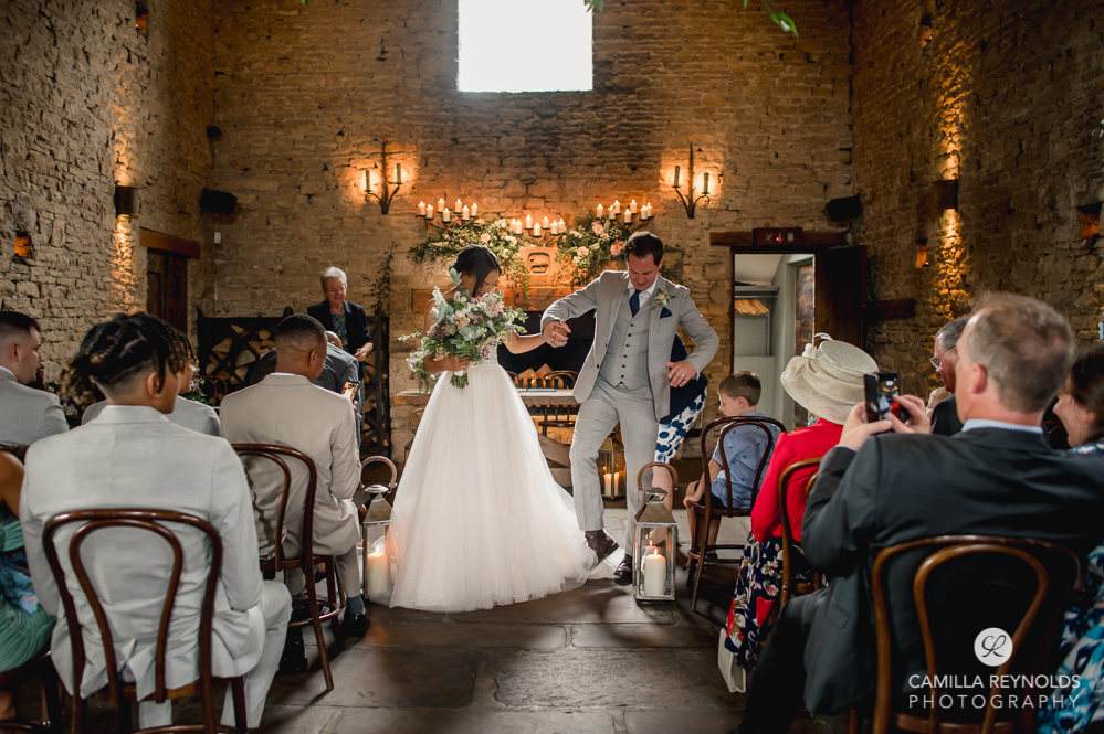 groom stepping on dress fun natural wedding photography cotswolds