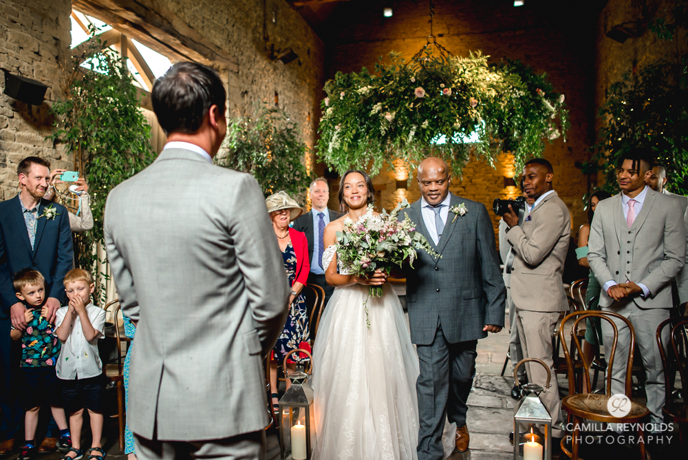 bride walking down aisle cripps barn gloucestershire cotswolds 