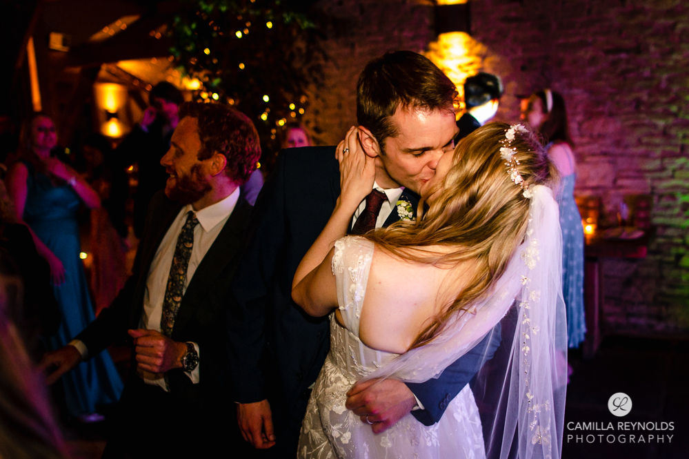 bride and groom kissing on dance floor cripps barn cotswold wedding