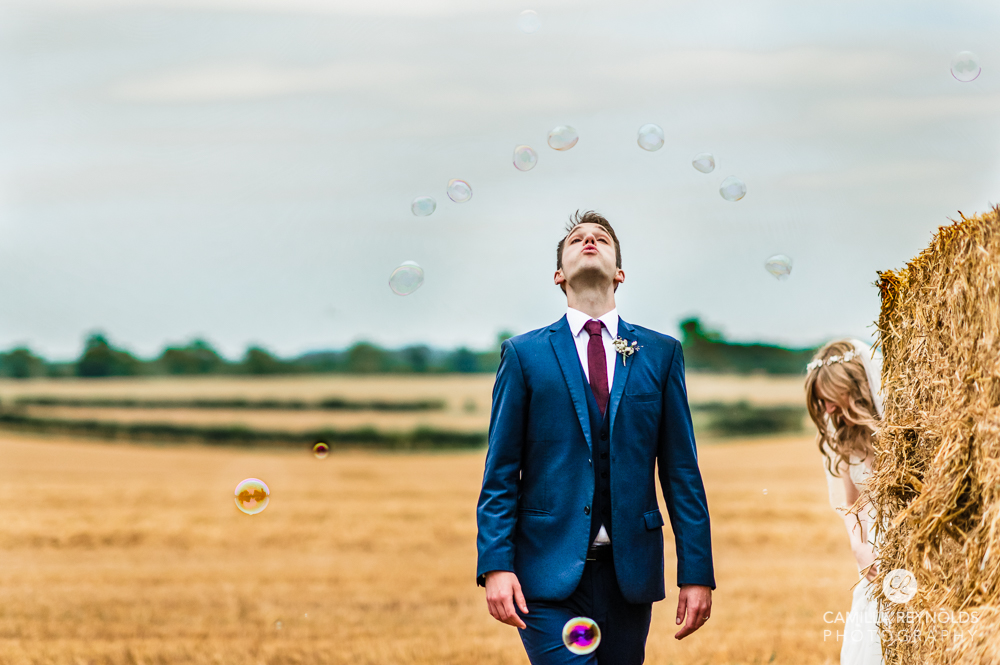 groom blowing bubbles fun wedding photography uk