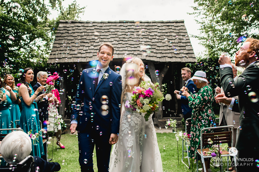 bride and groom with bubble confetti cripps barn cotswold wedding