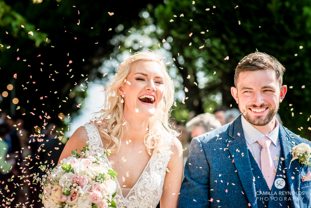 bride and groom happy laughing confetti shot wedding uk 