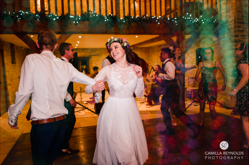 bride dancing  at Kingscote barn wedding cotswolds uk