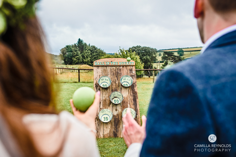 bride and groom games paddock Kingscote barn natural wedding photography