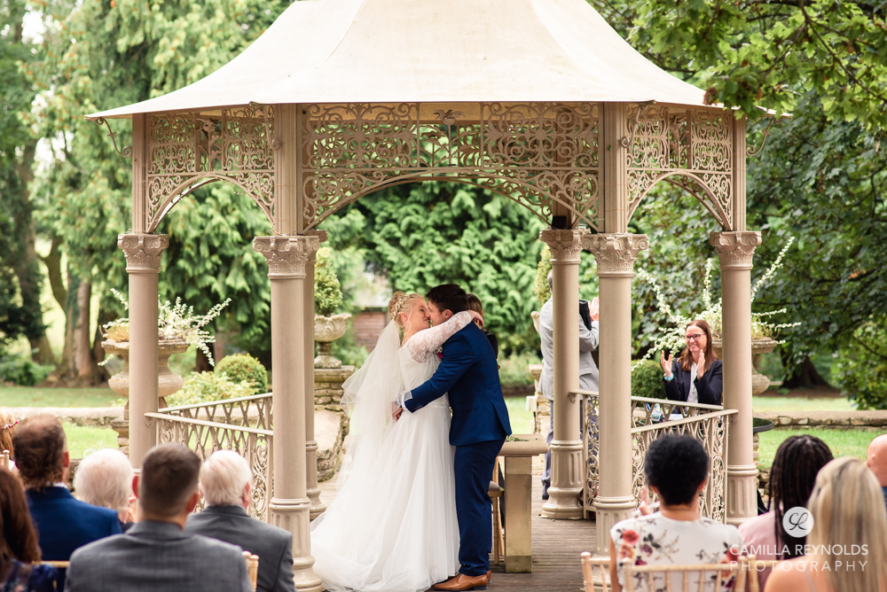 first kiss outdoor wedding ceremony photography eastington park uk
