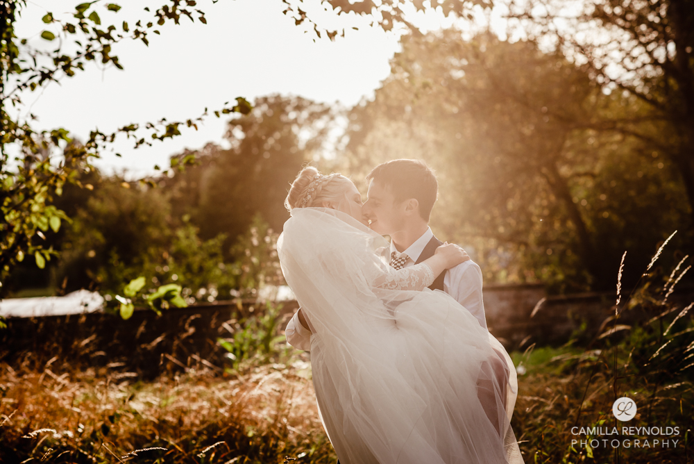 bride and groom kissing golden hour wiltshire wedding