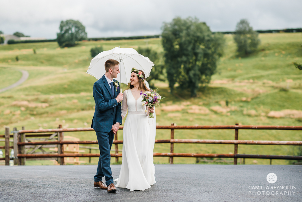 bride and groom walking kingscote barn wedding photography Cotswolds uk