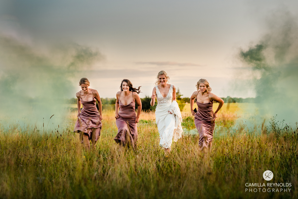 bride and bridesmaids in the field colourful wedding photography uk