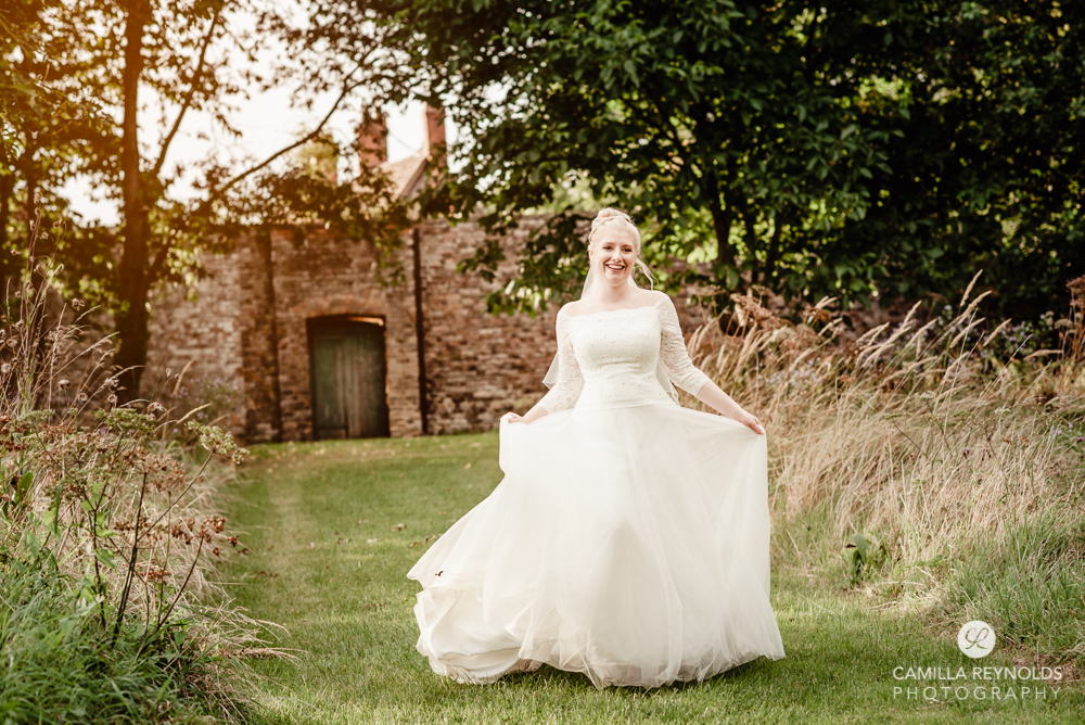 bride running castle romantic wedding photography cotswolds uk