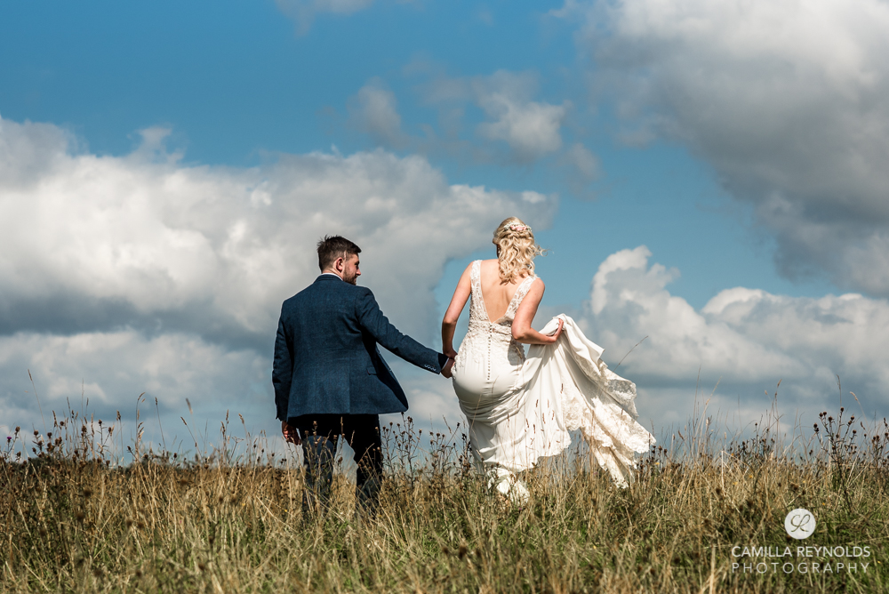 bride and groom walking sky wedding Gloucestershire