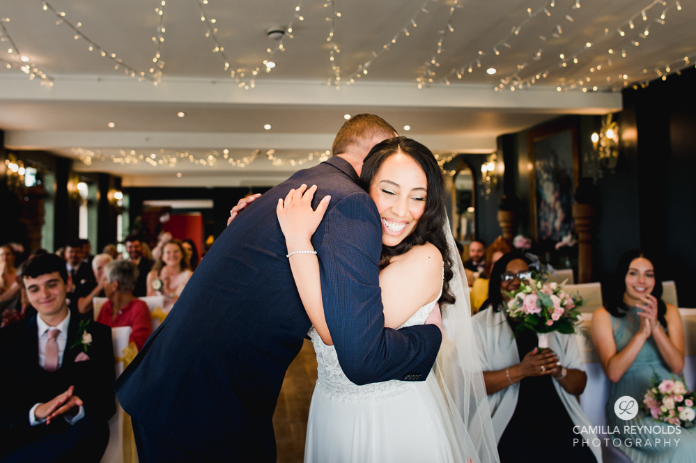 bride and groom hugging natural wedding photography uk