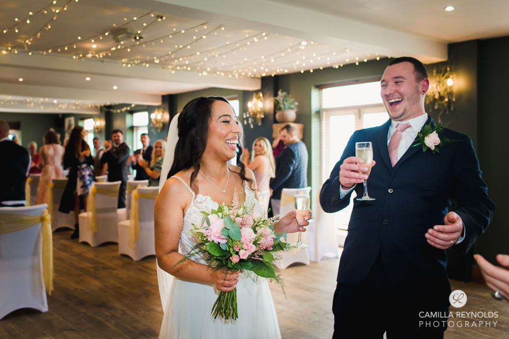 couple laughing fun colourful wedding photos cotswolds
