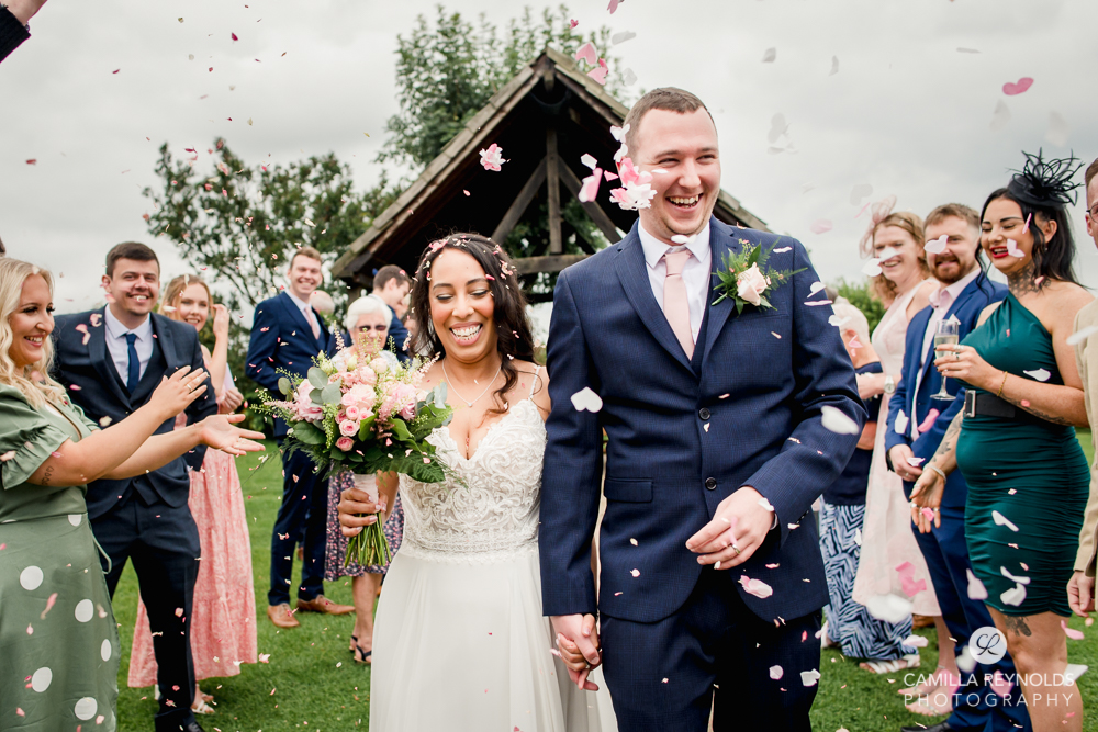 bride and groom walking confetti old lodge natural wedding stroud