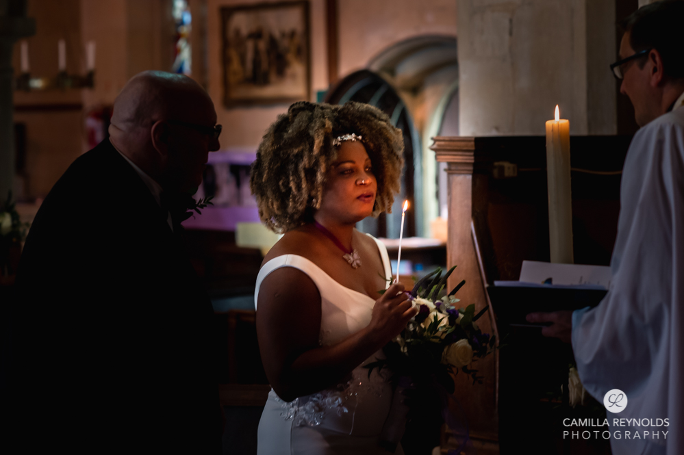 bride blowing candle church cotswold wedding photography