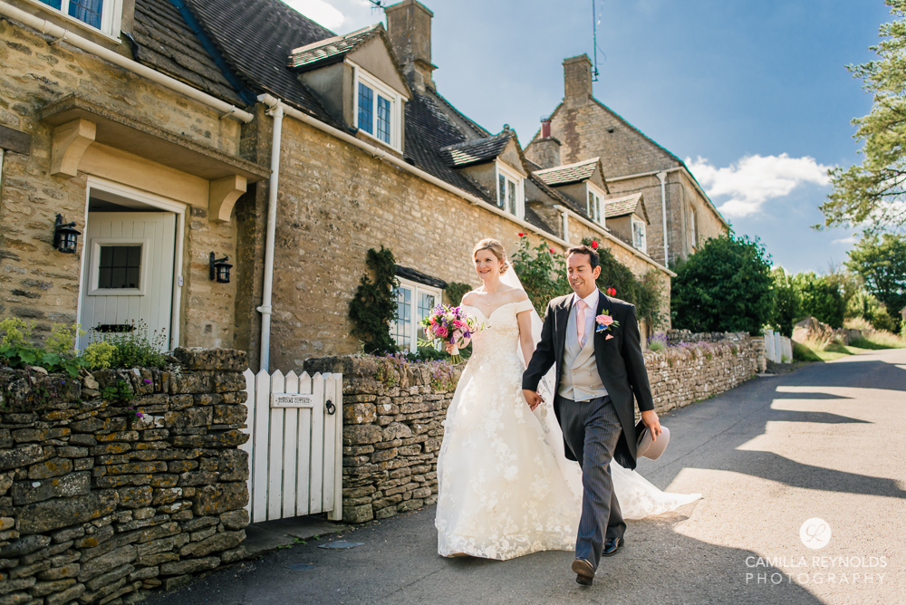 bride and groom walking cotswold village 