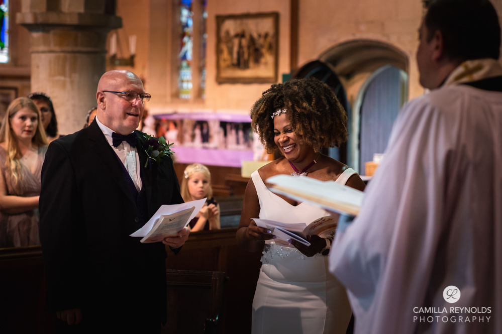 bride and groom laughing church wedding cotswolds