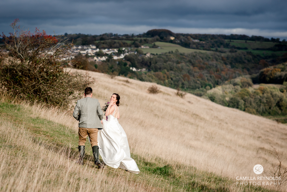 bride and groom walking rodborough common cotswold wedding photography