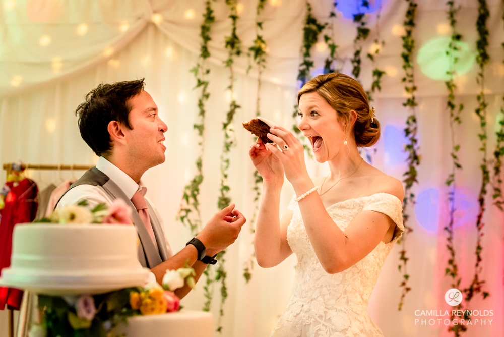 wedding cake cutting fun silly photography cotswolds