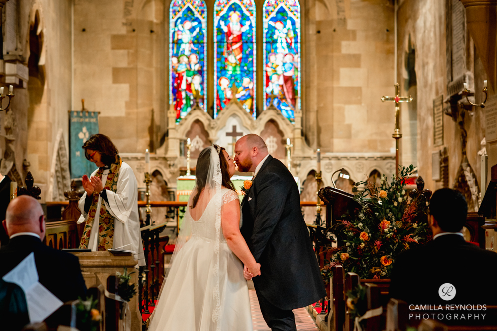 bride and groom kissing church wedding cotswolds