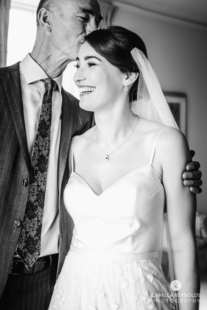 dad kissing bride wedding photography cotswolds