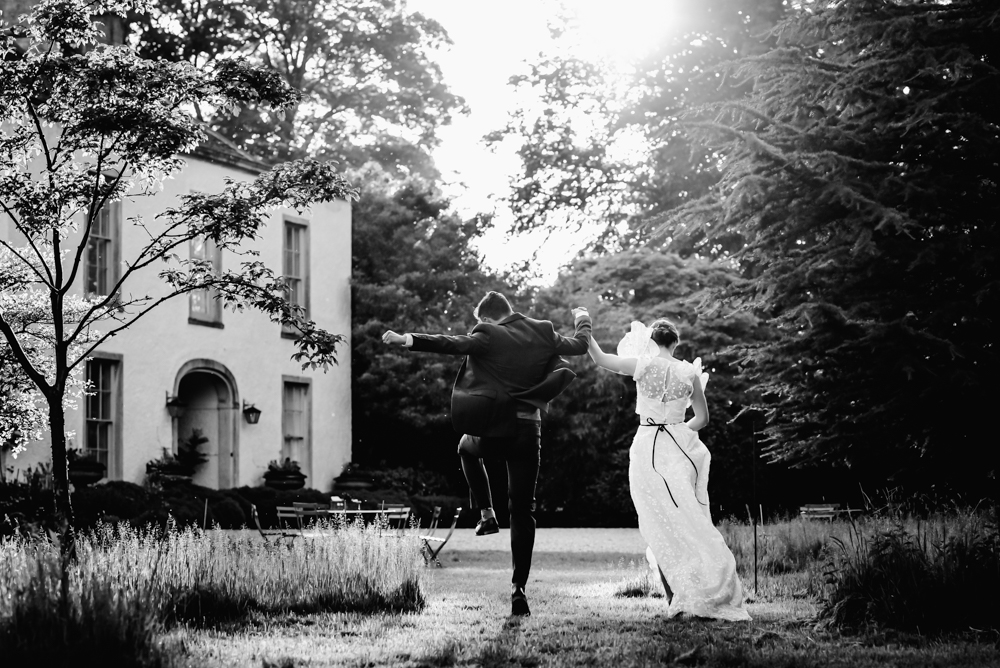 fun relaxed wedding photography bride and groom jumping uk