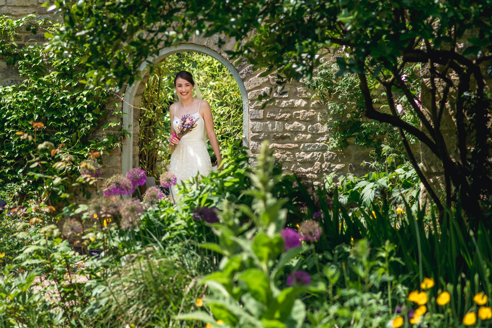 bride under garden arch matara cenrre cotswolds