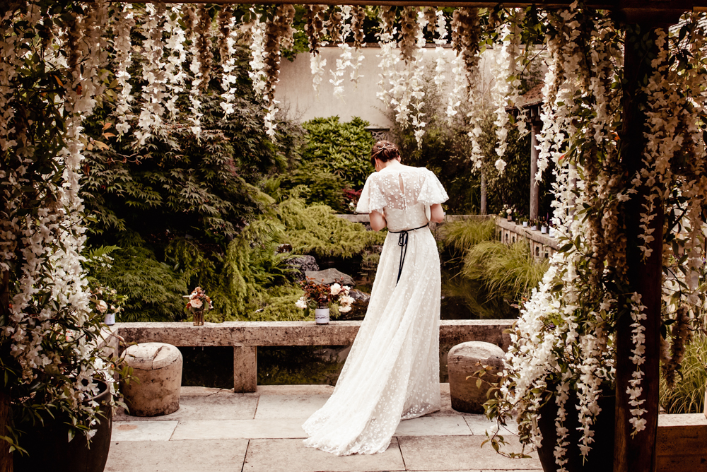 bride wisteria arch fine art wedding photography cotswolds
