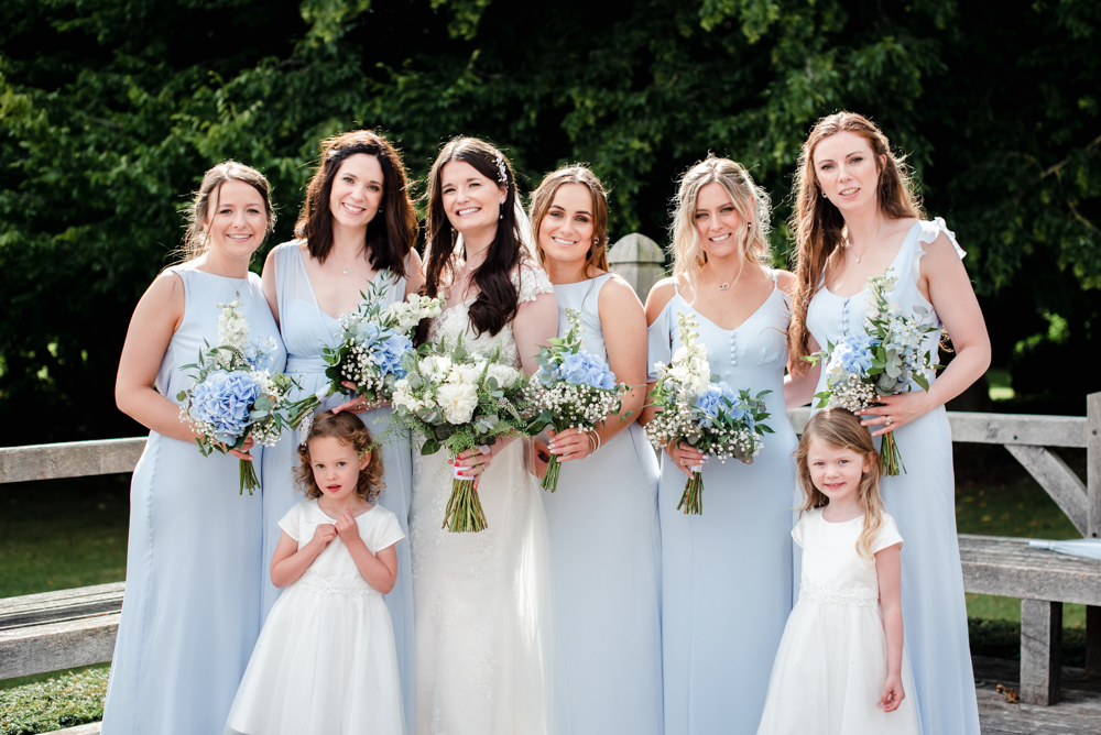 bride and bridesmaids in blue dress cripps barn wedding