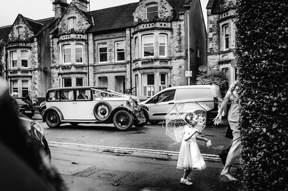 flower girl with umbrella natural wedding photography cirencester