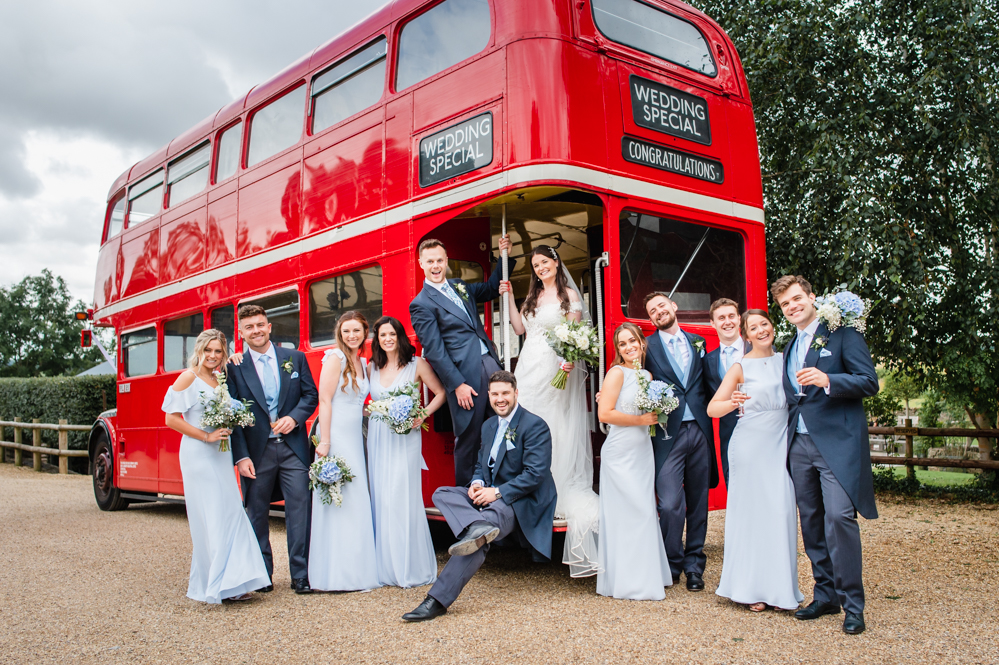 bridesmaids and groomsmen red london bus england