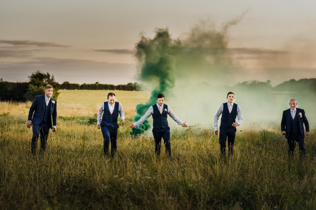 groom and groomsmen walking in countryside creative wedding photography