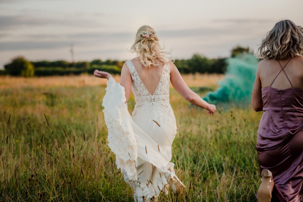 bride running in the countryside romantic wedding photography cotswolds
