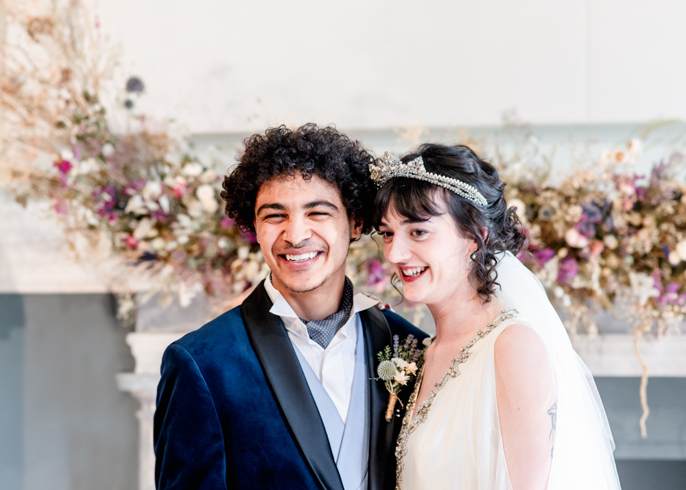 wedding couple in front of mantlepiece