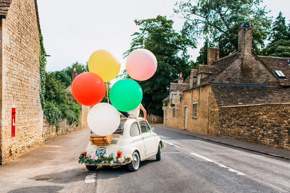 wedding car with giant balloons cotswold wedding