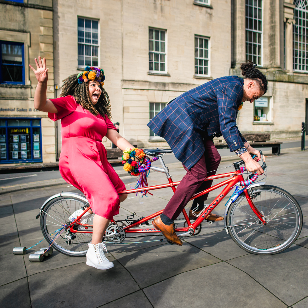 bride and groom cycling fun relaxed wedding photography
