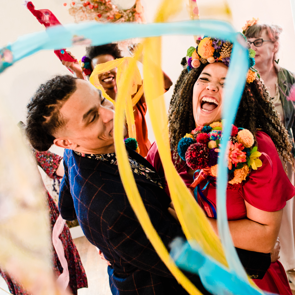 bright colourful wedding photography blue yellow ribbon wands