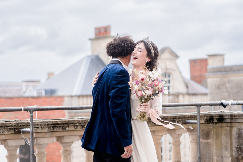 couple laughing on roof top balcony stroud cotswolds wedding