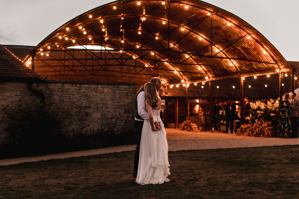 bride and groom hugging old gore barn 