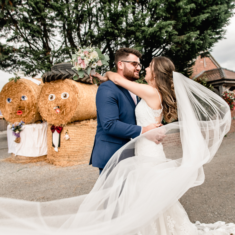 bride and groom hay bales cotswolds