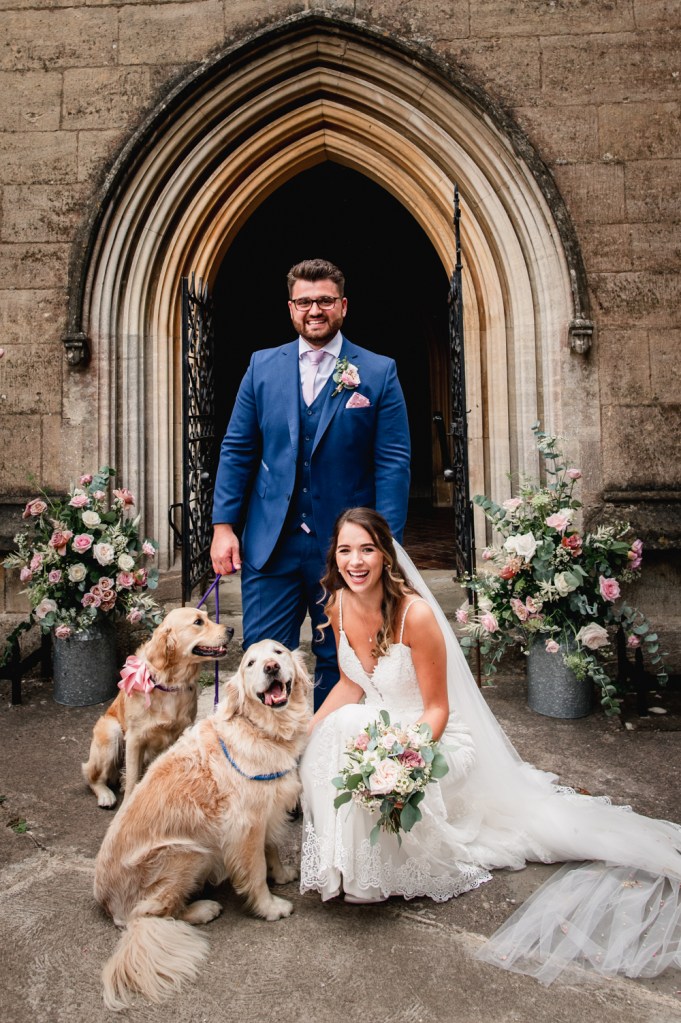 bride groom with dogs church wedding