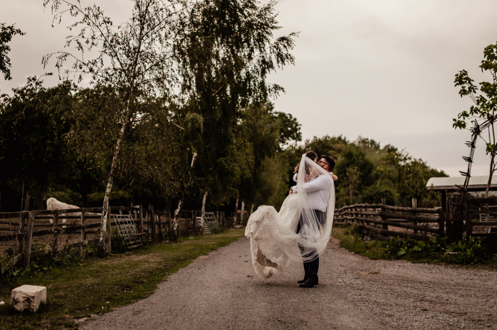 groom lifting bride farm