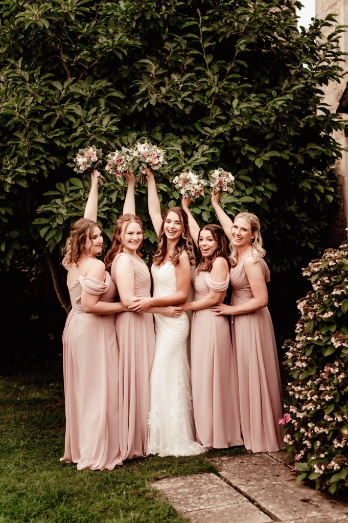 bride and bridesmaids hugging