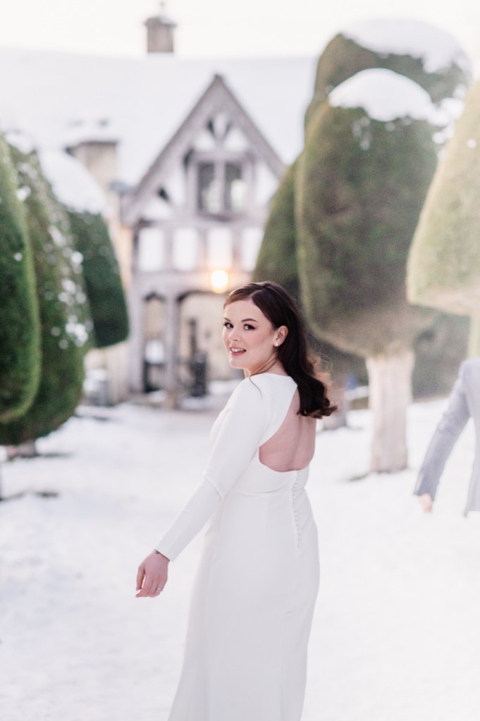 bride walking in the snow fine art wedding photos