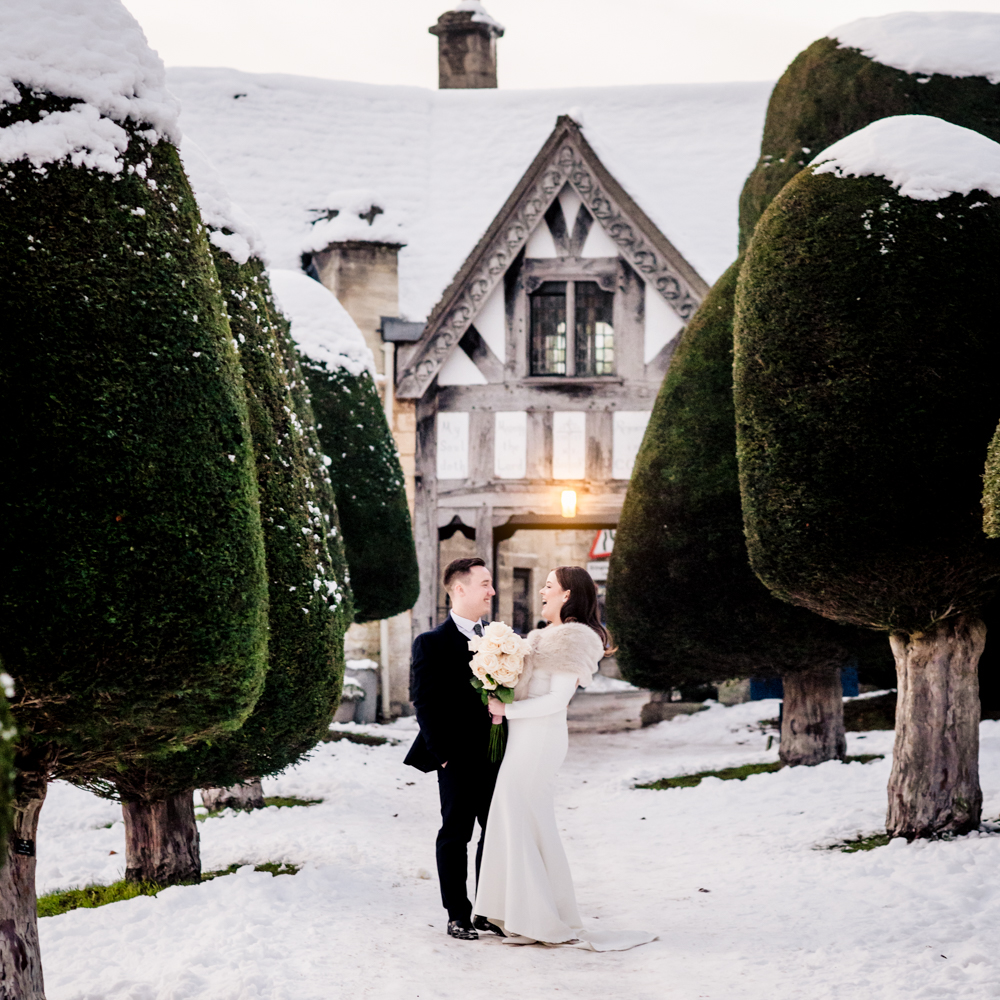bride and groom in the snow cotswolds wedding photography