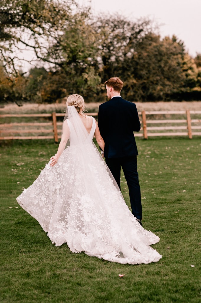 bride and groom walking countryside england